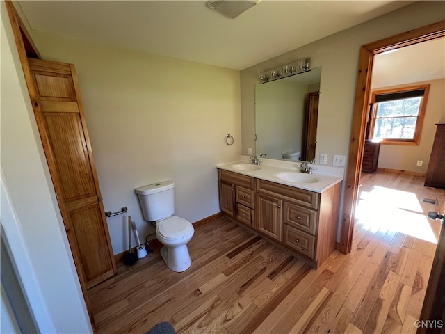 bathroom with vanity, hardwood / wood-style floors, and toilet