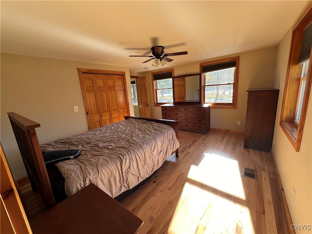 bedroom featuring light hardwood / wood-style floors, a closet, and ceiling fan