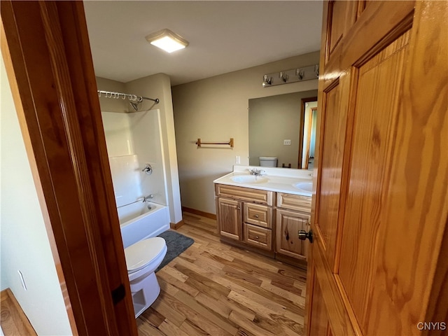 full bathroom with vanity, shower / tub combination, wood-type flooring, and toilet