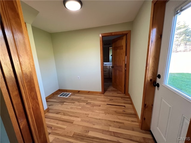 corridor with light wood-type flooring