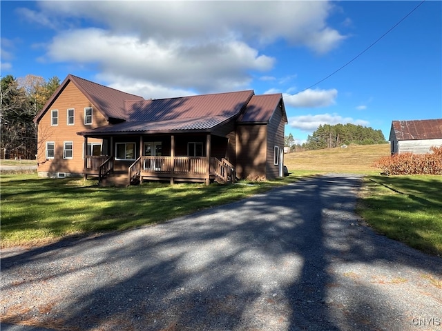 view of front of home featuring a front yard and covered porch