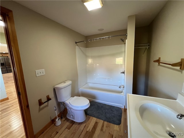 full bathroom featuring vanity, toilet, hardwood / wood-style flooring, and shower / bathing tub combination