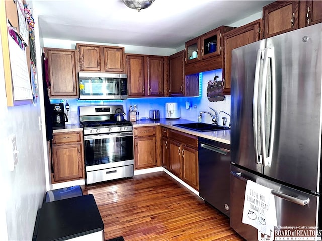 kitchen featuring dark wood-type flooring, appliances with stainless steel finishes, and sink