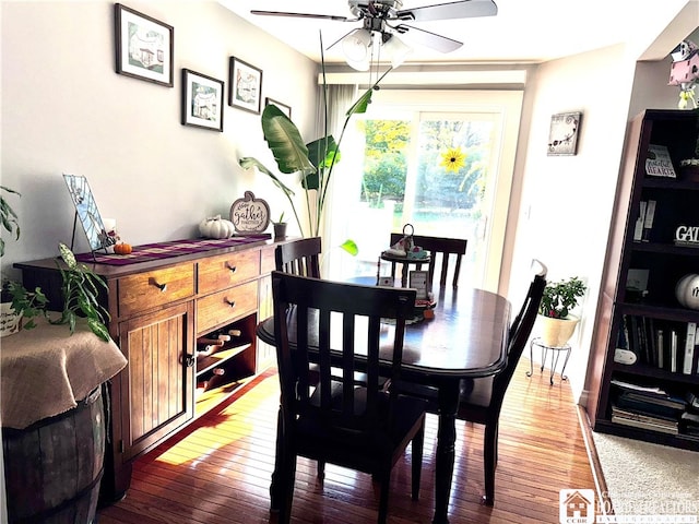 dining area with dark wood-type flooring and ceiling fan