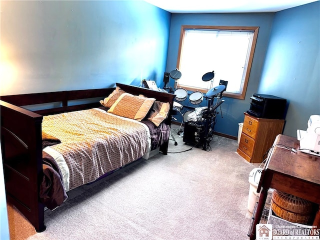 bedroom featuring light carpet