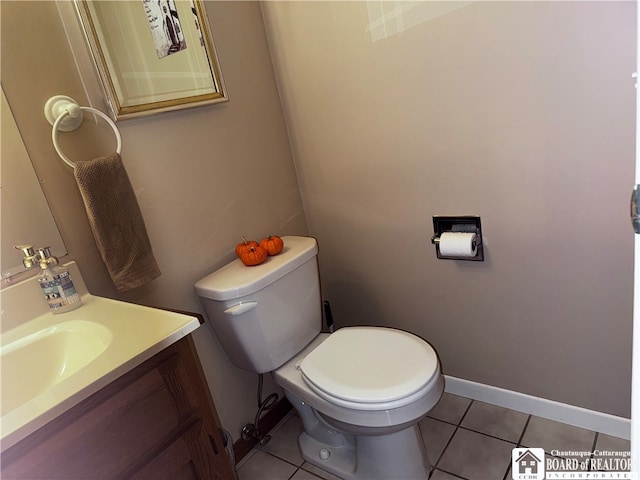 bathroom with vanity, toilet, and tile patterned flooring