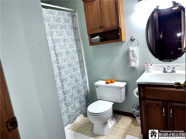 bathroom featuring vanity, a shower with shower curtain, and toilet