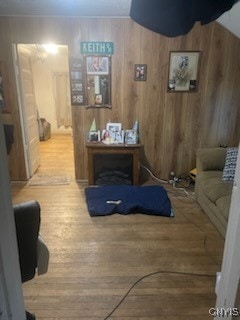 interior space with hardwood / wood-style floors and wood walls