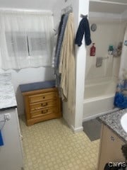 bathroom with vanity and shower / bath combo