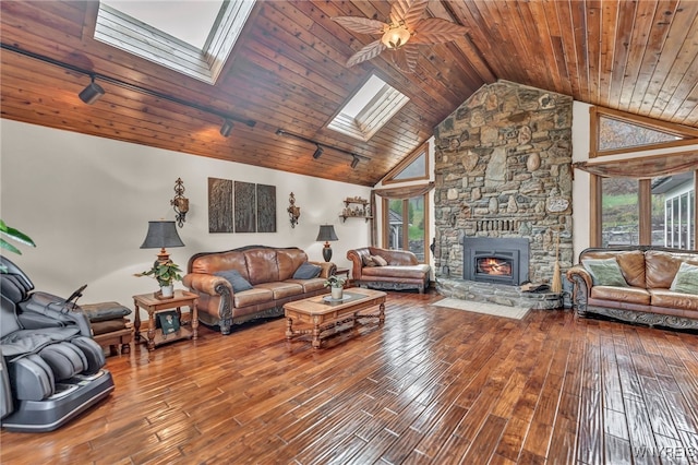 living room with wood-type flooring, wooden ceiling, a skylight, and plenty of natural light