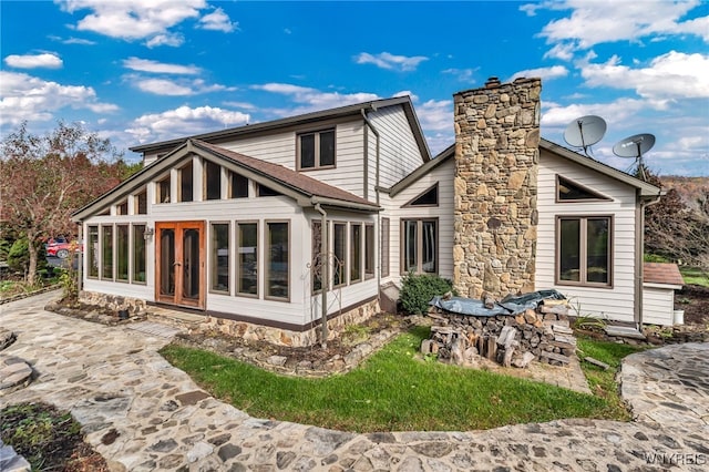 back of house with a sunroom