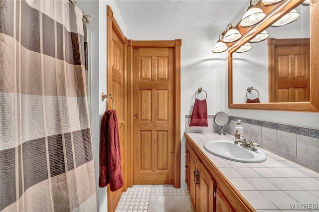 bathroom featuring vanity, a textured ceiling, and tile patterned flooring