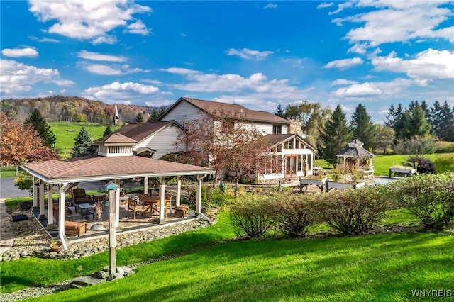 surrounding community with a patio, a gazebo, and a lawn