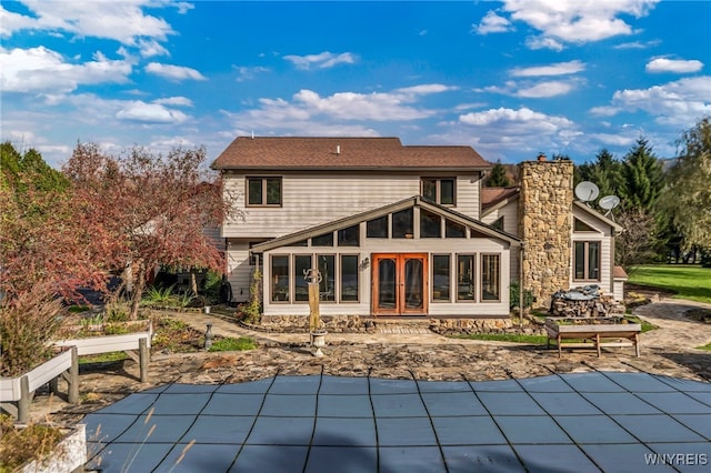 rear view of property featuring a patio area and a sunroom