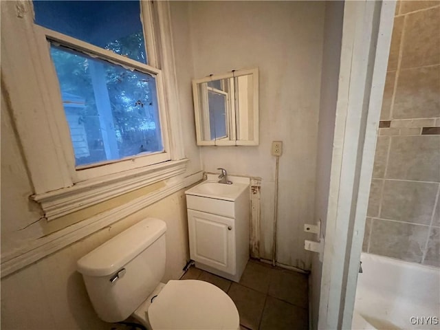 bathroom with tile patterned flooring, vanity, and toilet