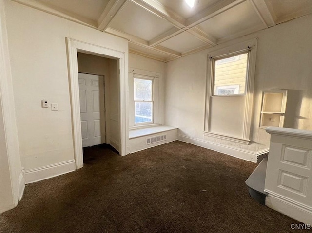 unfurnished bedroom featuring beamed ceiling, dark colored carpet, and coffered ceiling