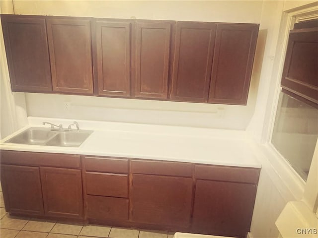 kitchen with light tile patterned flooring and sink