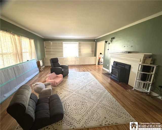 living room with a wealth of natural light, light wood-type flooring, and crown molding