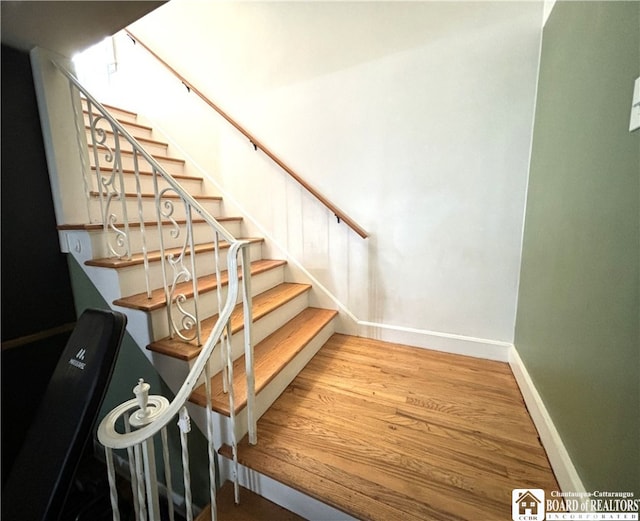 stairs with hardwood / wood-style floors