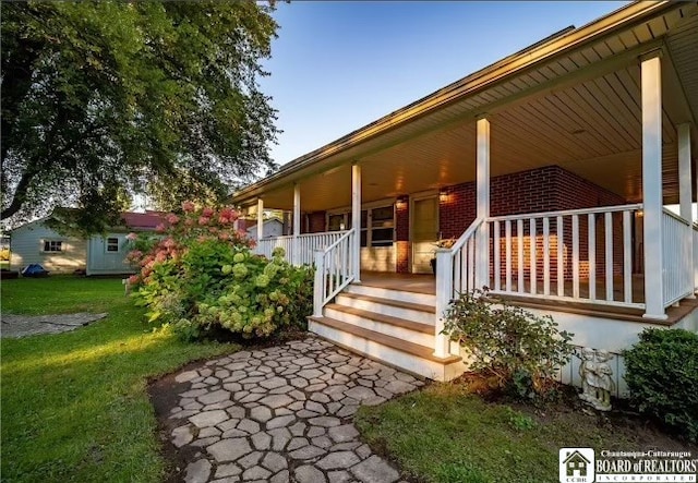 exterior space featuring a porch and a yard