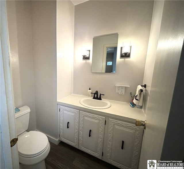 bathroom featuring hardwood / wood-style flooring, vanity, and toilet