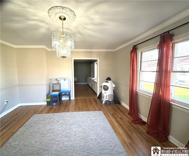 interior space featuring ornamental molding, dark hardwood / wood-style flooring, and a chandelier