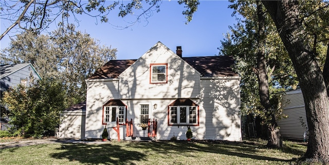 english style home with a front yard