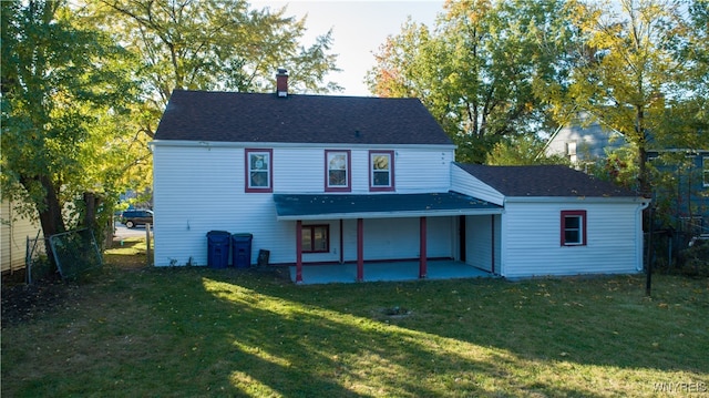 back of house featuring a patio and a lawn