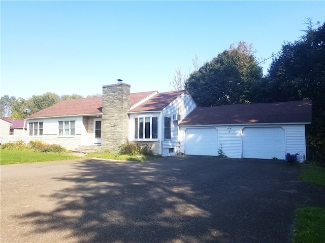 view of front of home featuring an outbuilding and a garage