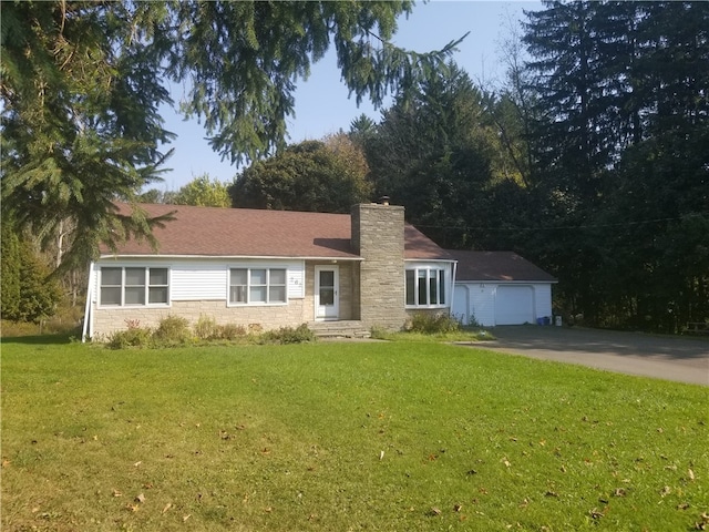 view of front of home with a front yard and a garage