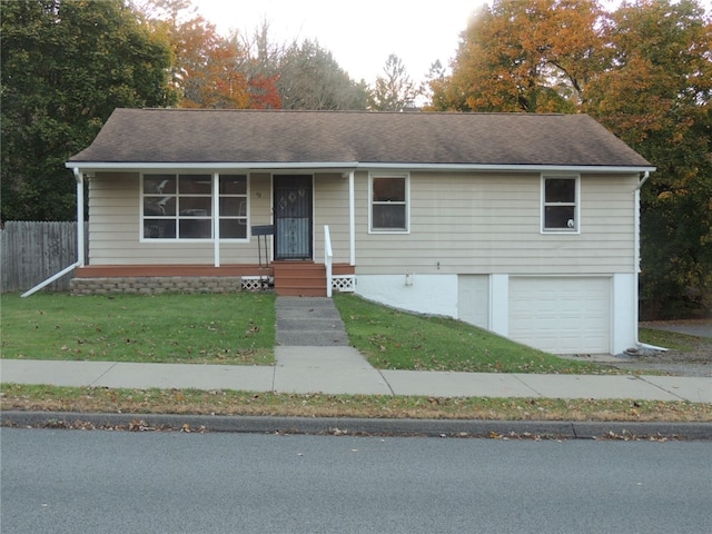 single story home featuring a garage and a front lawn