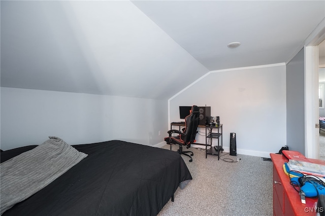 bedroom with carpet floors and vaulted ceiling