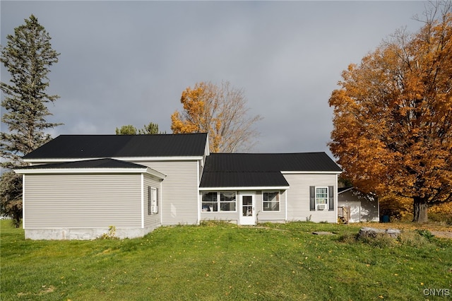 rear view of house with a yard