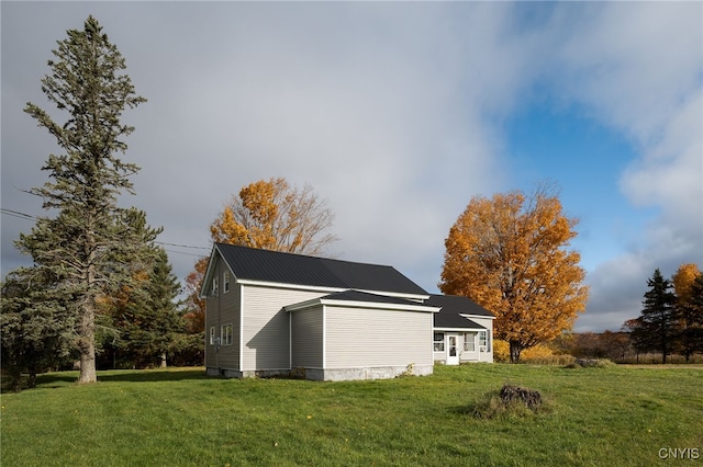 view of side of home featuring a yard