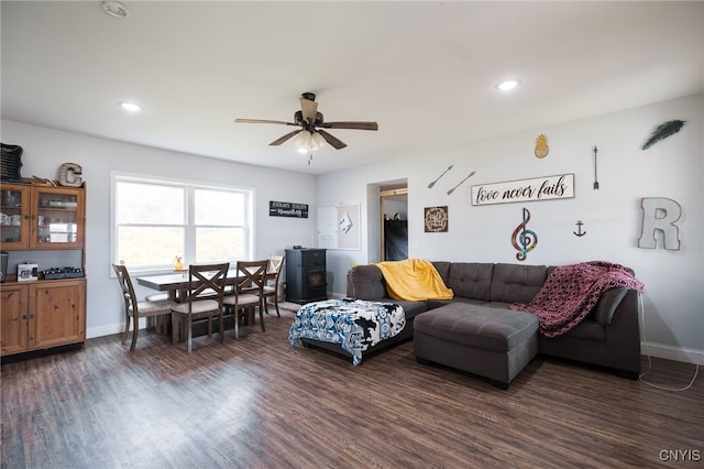 living room with ceiling fan and dark hardwood / wood-style flooring