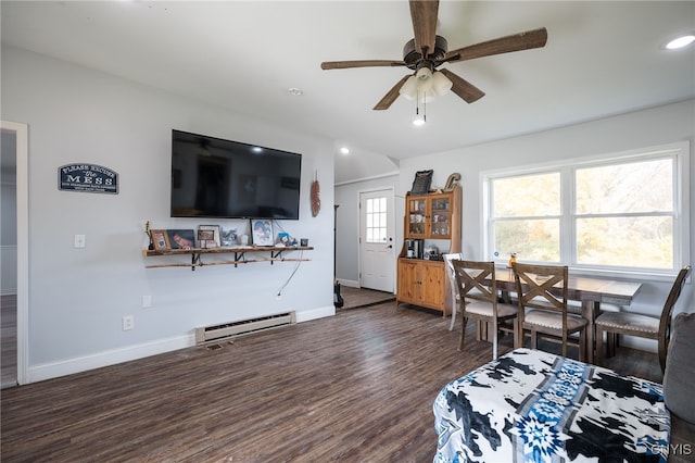 living room featuring baseboard heating, ceiling fan, and dark hardwood / wood-style flooring