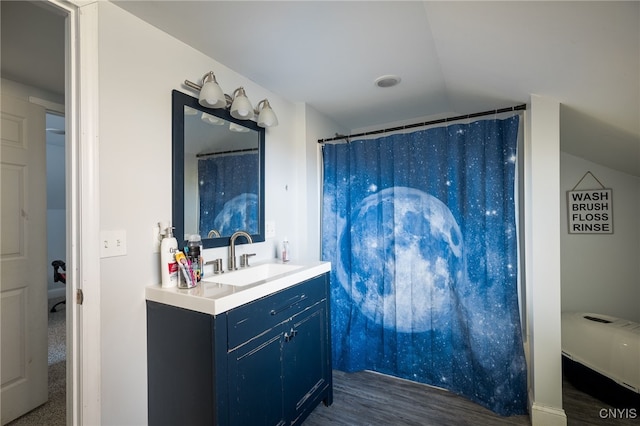 bathroom featuring vanity, lofted ceiling, wood-type flooring, and a shower with shower curtain