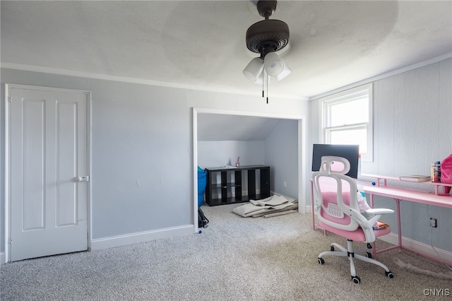 carpeted home office featuring lofted ceiling, crown molding, and ceiling fan