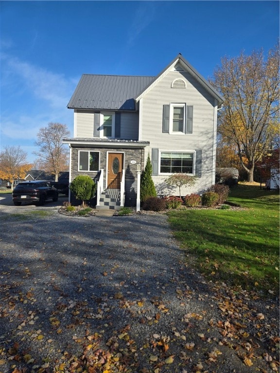 front facade with a porch and a front lawn