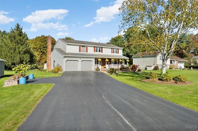 view of front of property featuring a front yard and a garage