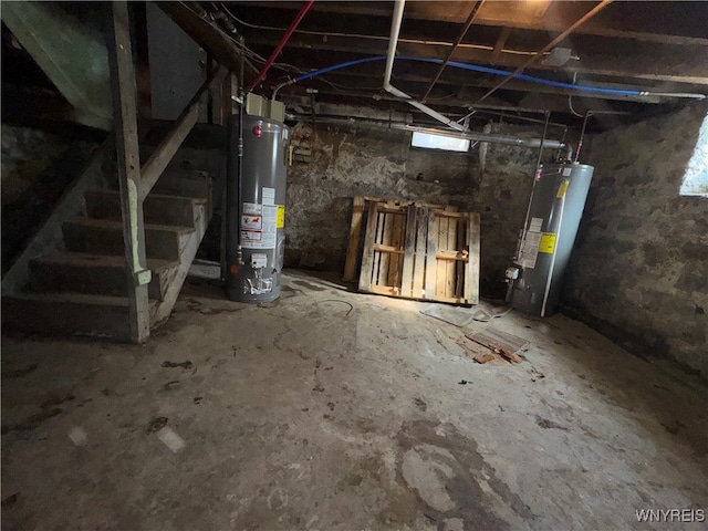 basement featuring a healthy amount of sunlight and water heater