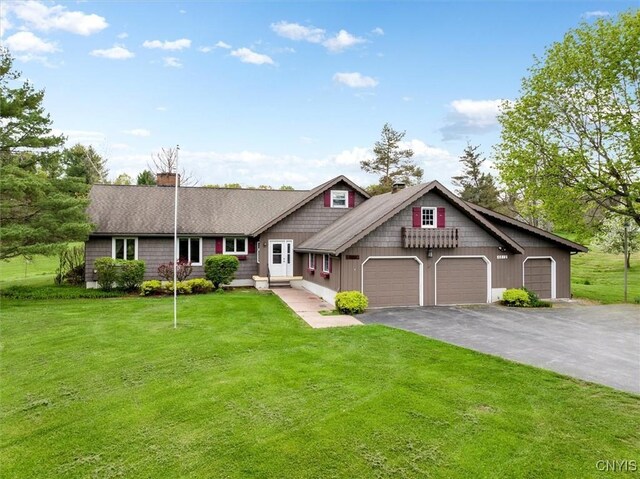 view of front of property with a front lawn and a garage