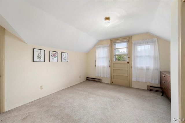 bonus room with a baseboard radiator, lofted ceiling, and light colored carpet