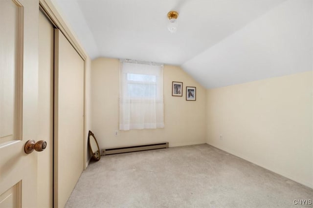 bonus room featuring lofted ceiling, a baseboard heating unit, and light colored carpet