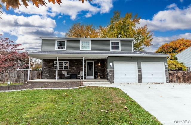 view of front property with a porch, a front lawn, and a garage