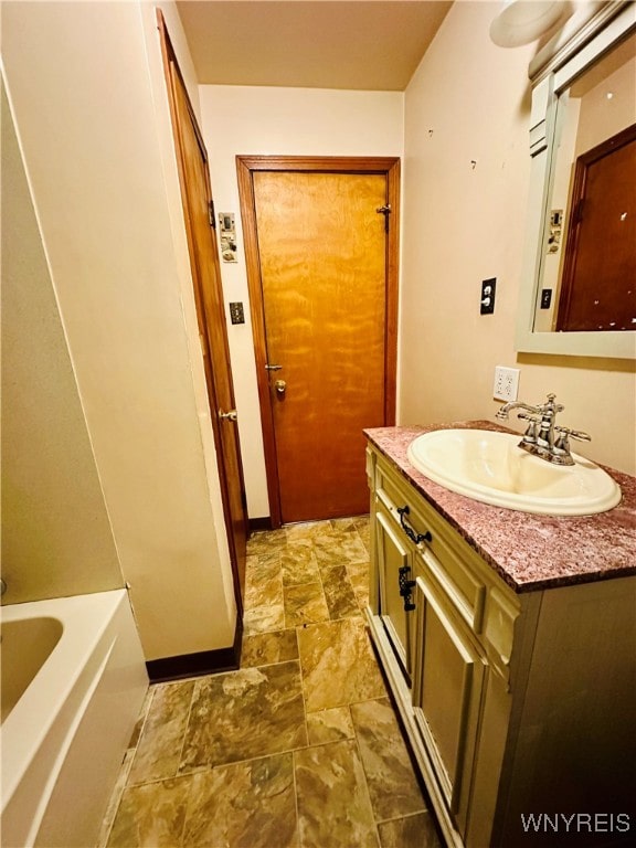 bathroom featuring vanity and a bathing tub