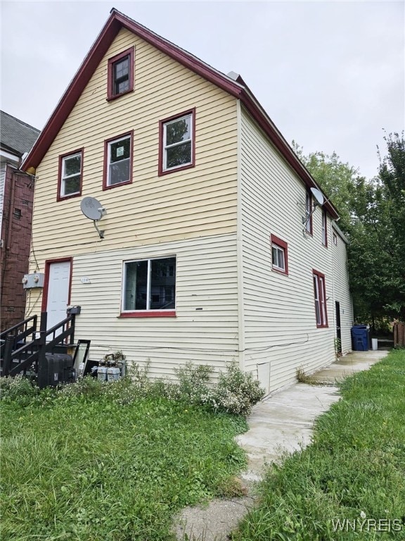 rear view of house with a lawn