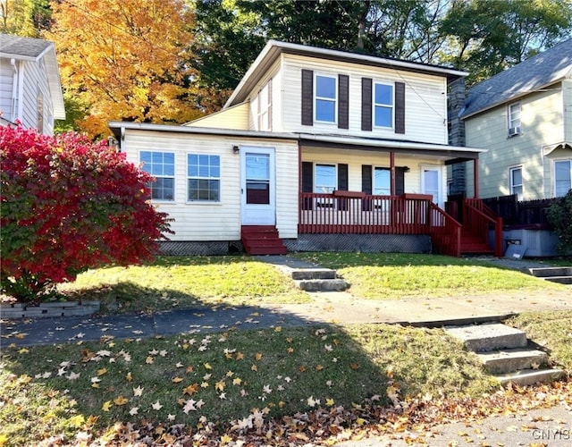 view of front of property with a porch and a front lawn