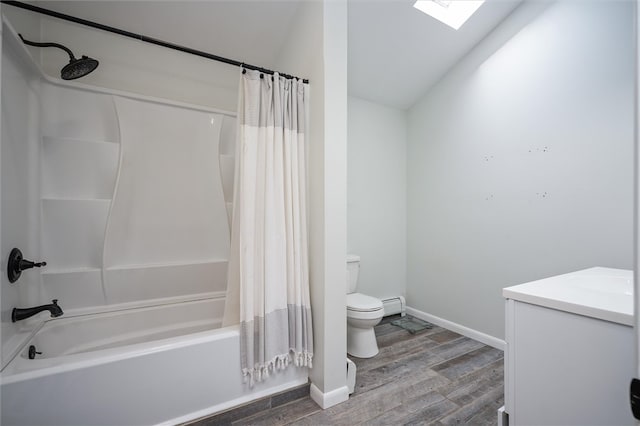 full bathroom with hardwood / wood-style floors, shower / bath combination with curtain, toilet, a skylight, and vanity