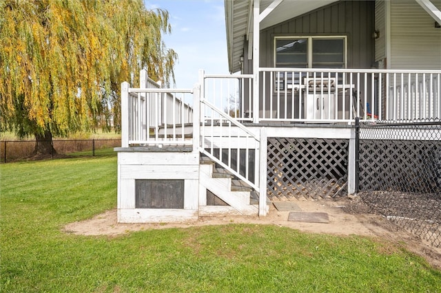 rear view of property with a deck and a yard